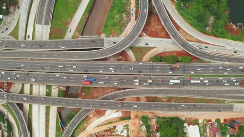 Top down view of Depok Antasari toll road intersection from a drone flying from left to right. Shot in 4k resolution photo