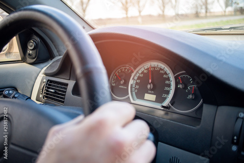 the driver speeds up. Car interior. Violation of auto rules. hands on the wheel © Александр Ивчик
