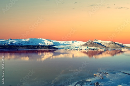 Dawn sky in Iceland over frozen over Lagoon