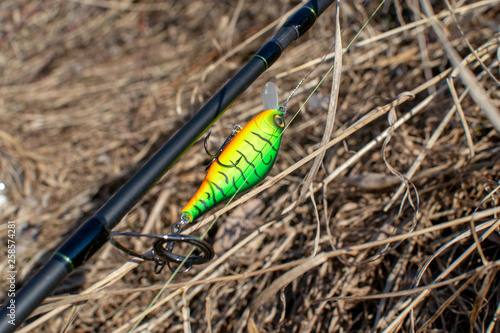 Fishing lures and spinning tackle on the grass. Fishing in the spring.