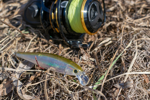 Fishing lures and spinning tackle on the grass. Fishing in the spring.