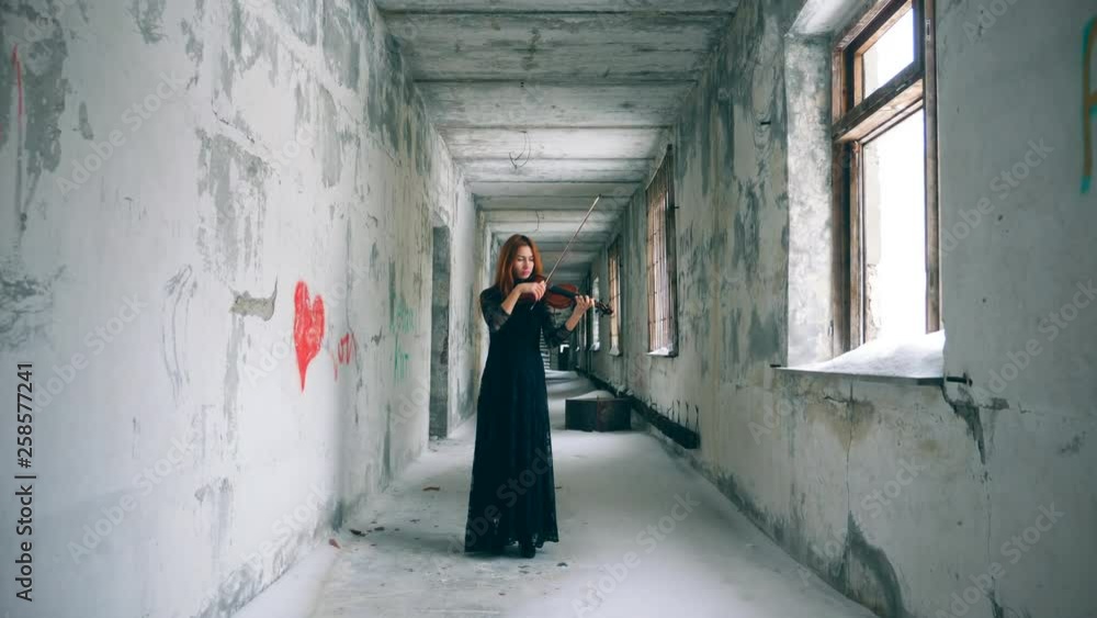 Rundown corridor with a female violin-player Rundown corridor with a female violin-player