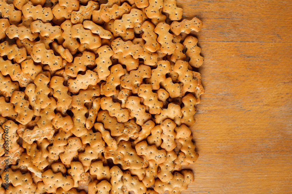 Composition of crackers with poppy seeds laid out on a wooden background Composition of crackers with poppy seeds laid out on a wooden background
