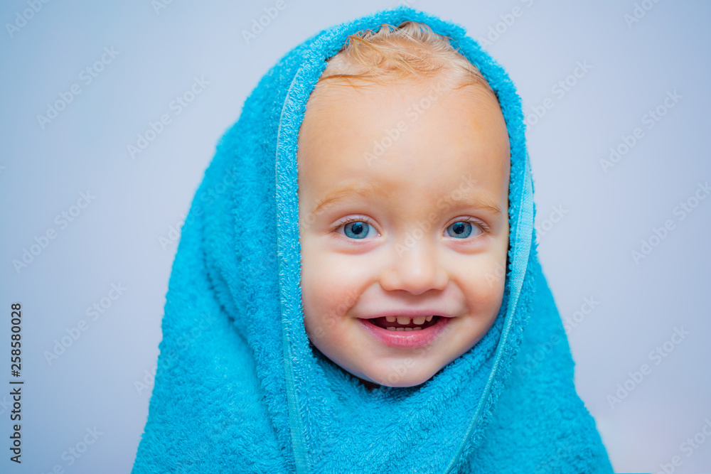Smiling beautiful baby bathing under a shower at home. Little baby washing with a bubbles in bath in a hat. Happy bath time. Baby Blue eyes. Smiling beautiful baby bathing under a shower at home. Little baby washing with a bubbles in bath in a hat. Happy bath time. Baby Blue eyes.