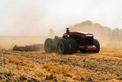 Autonomous tractor working on the field. Smart farming photo