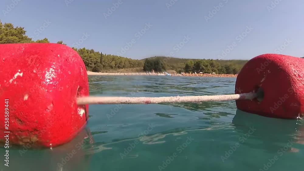 Red buoy on Blue Horizons Beach, Montenegro Red buoy on Blue Horizons Beach, Montenegro