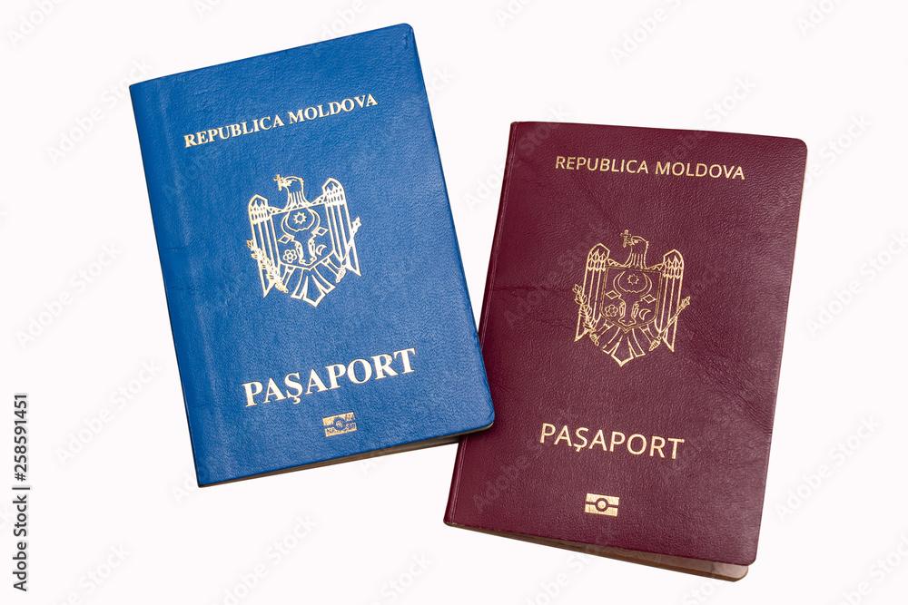 Biometric passports of citizens of the Republic of Moldova of red and blue colors isolated on white background. Covers of documents of different colors. Inscription - Republic of Moldova, Passport Biometric passports of citizens of the Republic of Moldova of red and blue colors isolated on white background. Covers of documents of different colors. Inscription - Republic of Moldova, Passport