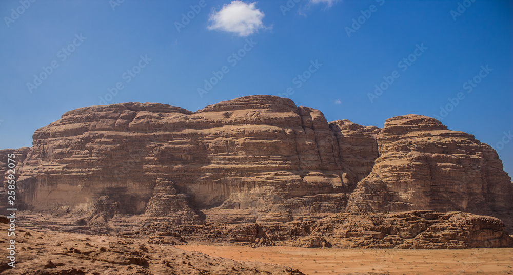 picturesque panorama view of Middle East Wadi Rum desert mountain ridge on sunny blue sky background In Jordan picturesque panorama view of Middle East Wadi Rum desert mountain ridge on sunny blue sky background In Jordan