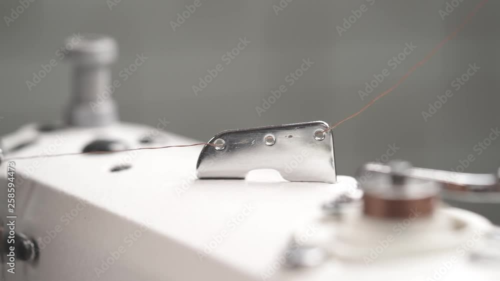 A close-up video of a high quality sewing machine in work. Textile manufacturing concept A close-up video of a high quality sewing machine in work. Textile manufacturing concept