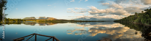 Panoramic view of sunrise over three small mountains. Canaima National Park, Venezuela