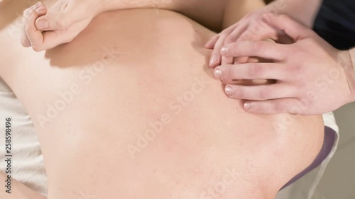 Wallpaper Mural Close-up Young male physiotherapist masseur doing therapeutic massage with hand stretching and shoulder blades for men in the massage room Torontodigital.ca