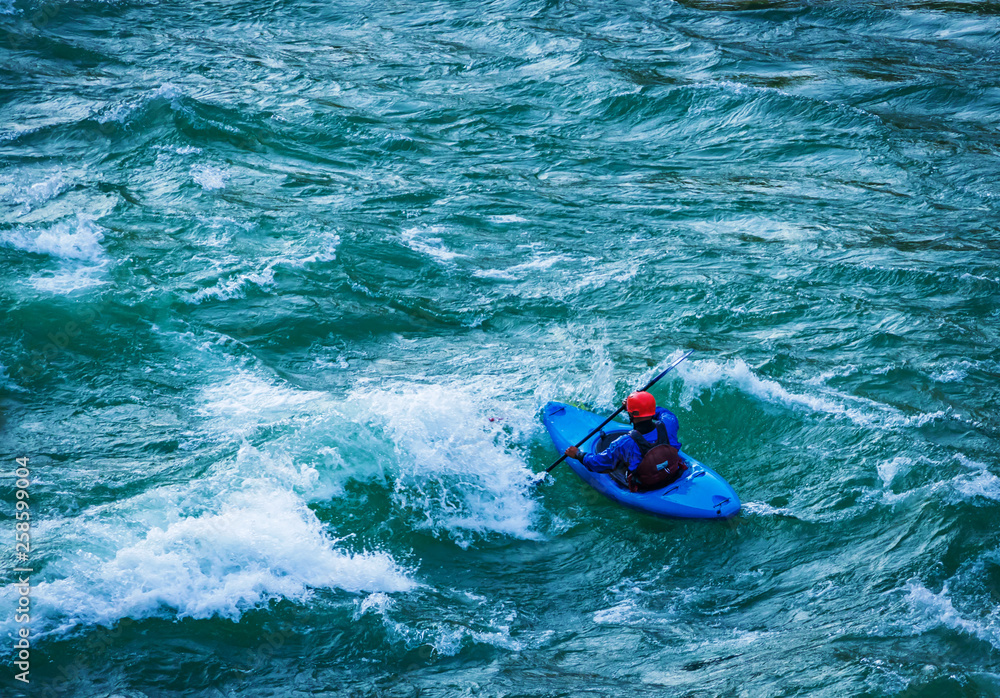top view of Whitewater kayaking, extreme kayaking. A guy in a kayak sails on a mountain river Ganges in Rishikesh,  India