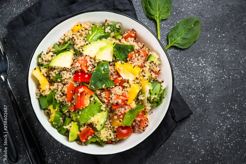 Quinoa salad with fresh vegetables on black. Quinoa salad with fresh vegetables on black.