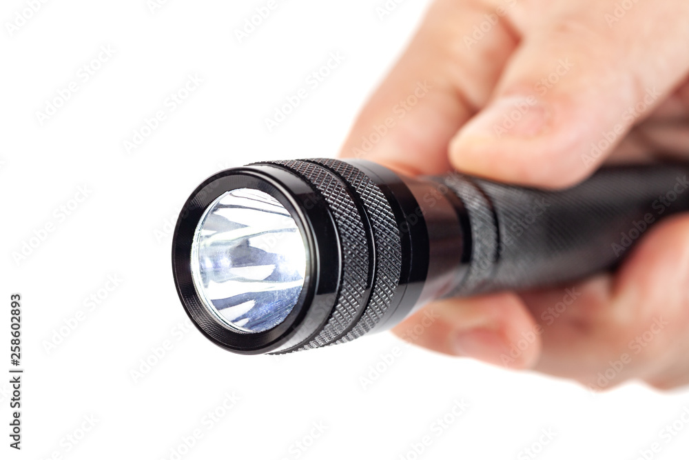 Hand holding flashlight on white background Hand holding flashlight on white background