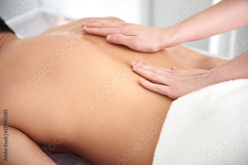 Close up of therapist making oil massage
