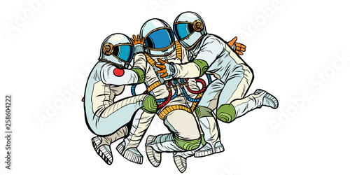 three astronauts hugging