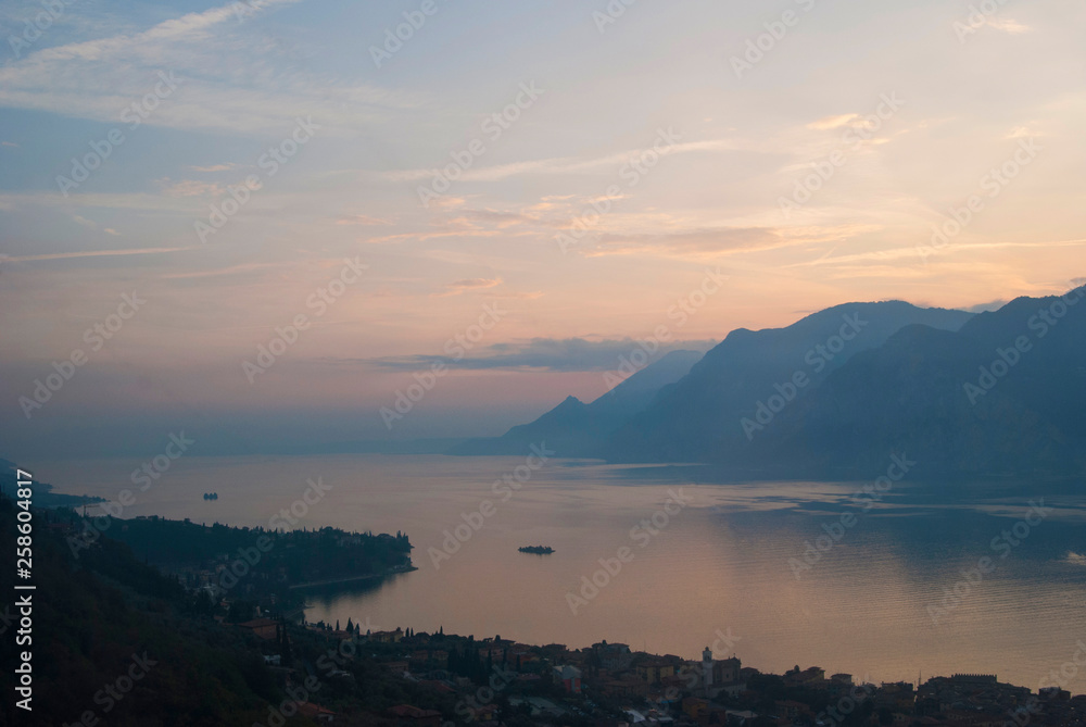 Scenic view of sunset at Lake Garda in the evening, Veneto, Italy. Panoramic view at Lake Garda landscape from top of the Monte Baldo