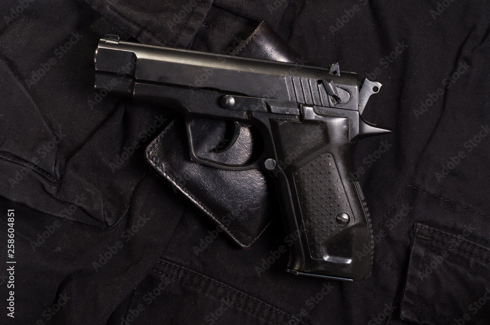 Pistol and leather wallet. Wallets and gun. Pistol and leather wallet. Wallets and gun.
