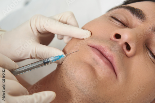 Close up man on facial beauty shot procedure