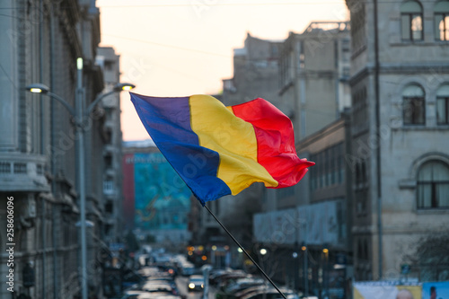 Romanian flag with Bucharest city background photo