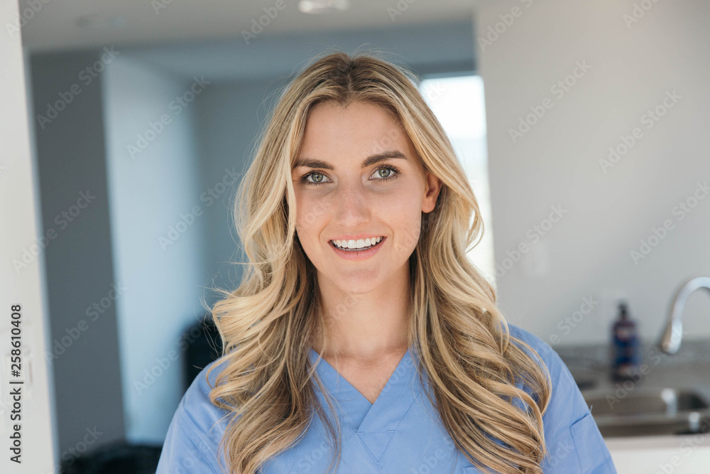 Blonde nurse wearing blue scrubs Blonde nurse wearing blue scrubs