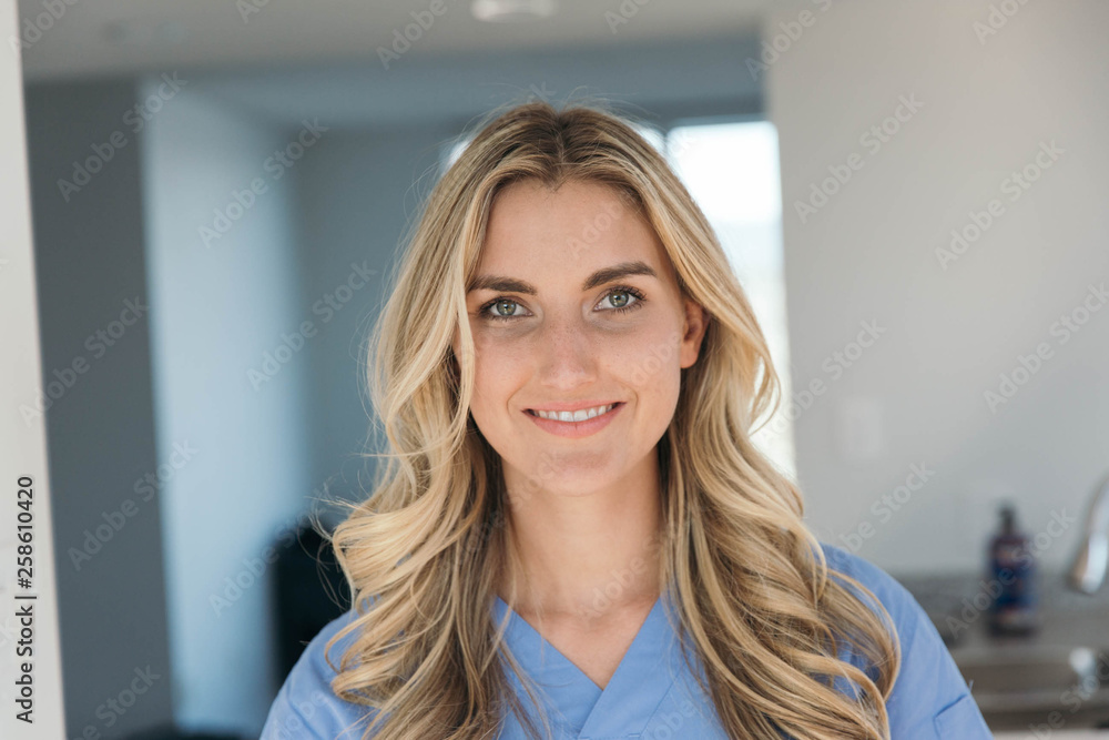 Blonde nurse wearing blue scrubs Blonde nurse wearing blue scrubs