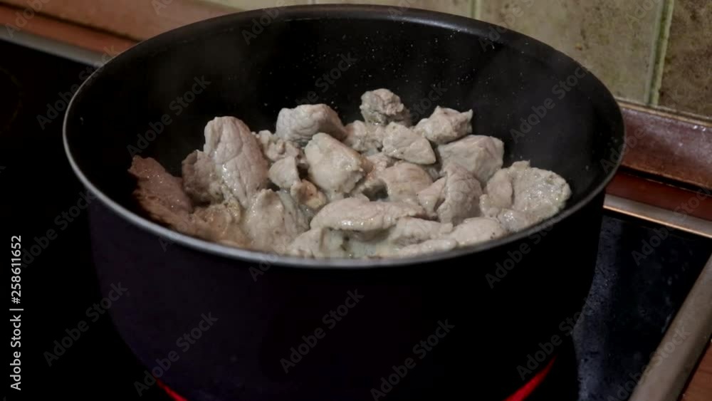 Chopped meat frying in a stew-pan on electric hob, steam is coming up Chopped meat frying in a stew-pan on electric hob, steam is coming up