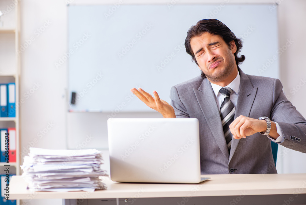 Young handsome businessman employee in the office Young handsome businessman employee in the office