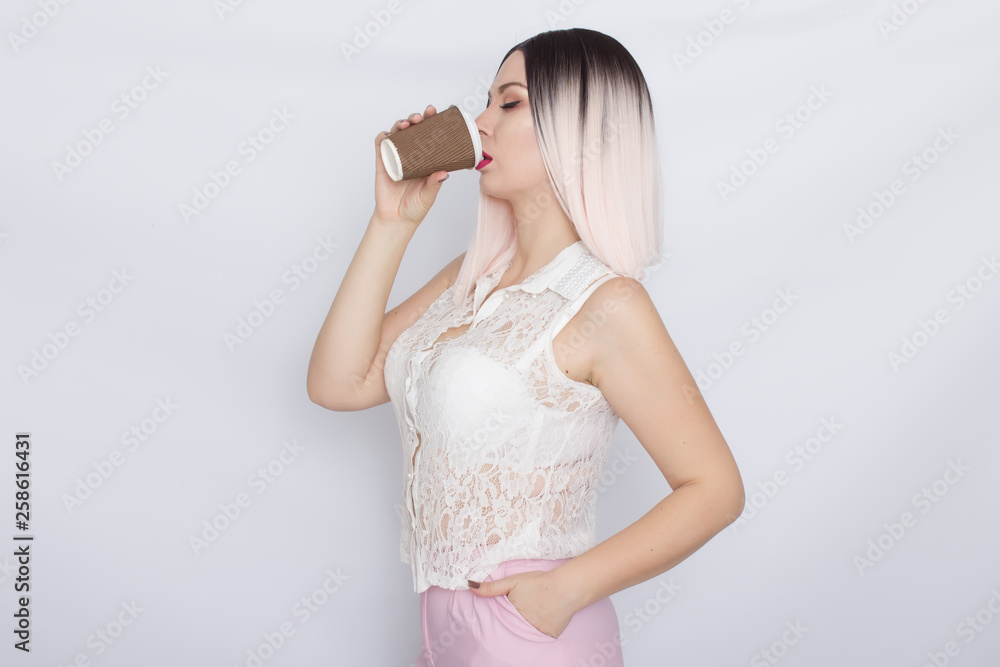 Blonde woman in white shirt with cup of coffee Blonde woman in white shirt with cup of coffee