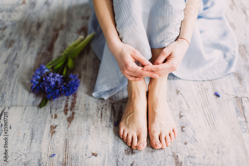 Female legs and spring flower hyacinth photo