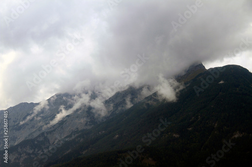 A wet day for the misty rocky mountains covered in snow and surrounded by big thick fog