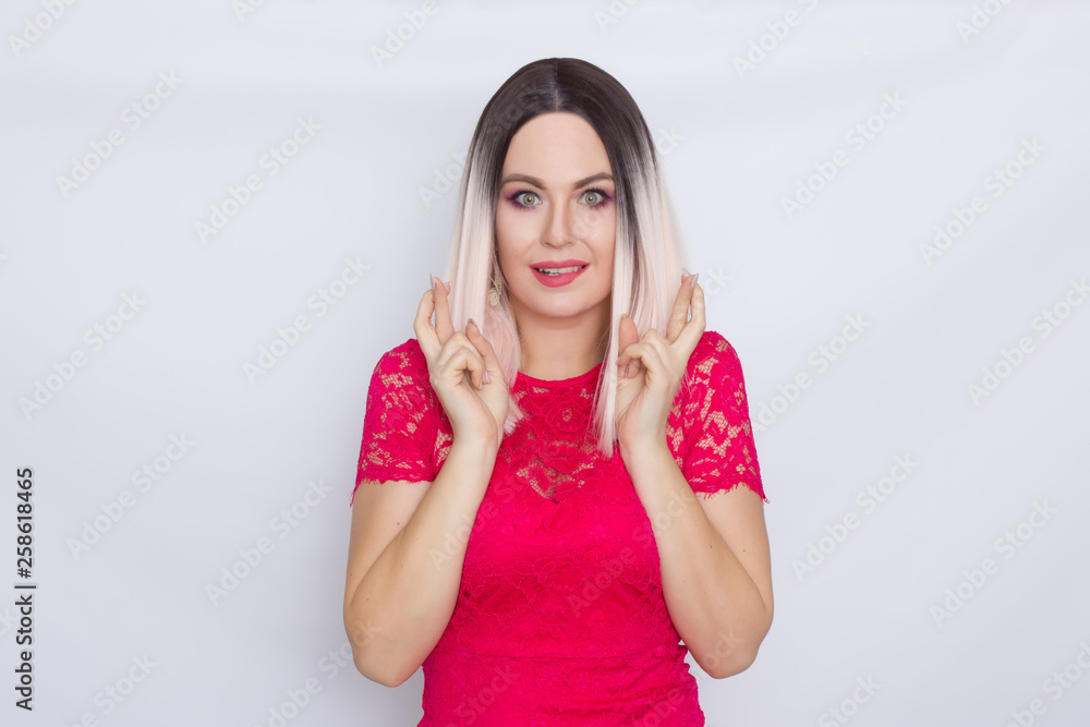 Young blonde woman over white background in bright pink dress Young blonde woman over white background in bright pink dress