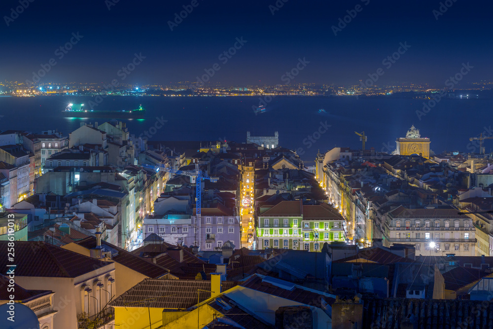 Night long exposure aerial cityscape. View of historic central quarters, Commerce Square, Triumphal Rua Augusta Arch and Tagus river in evening illumination, Lisbon, Portugal.