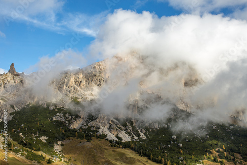The Cirspitzen, Cime Cir, covered in thick clouds while the Sky is Blue. The Dolomites in Fall