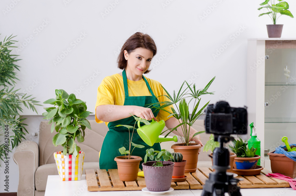 Female blogger explaining houseplants growing Female blogger explaining houseplants growing
