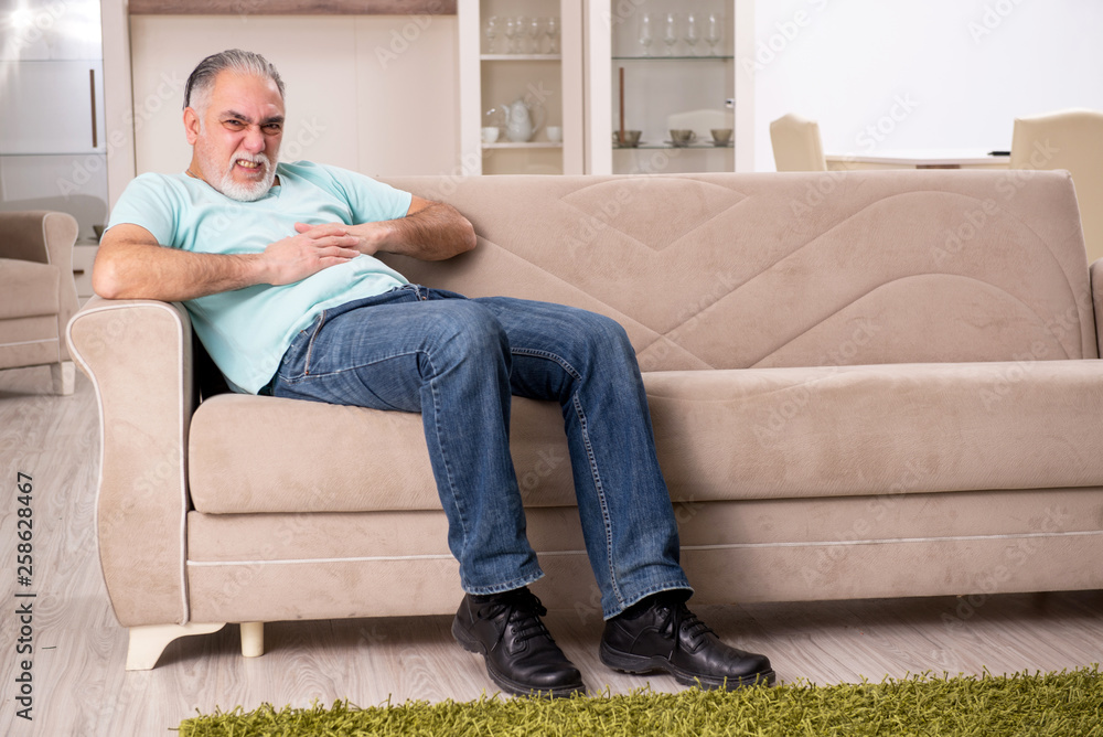 White bearded old man suffering at home White bearded old man suffering at home