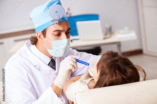 Young woman visting male doctor otolaryngologist