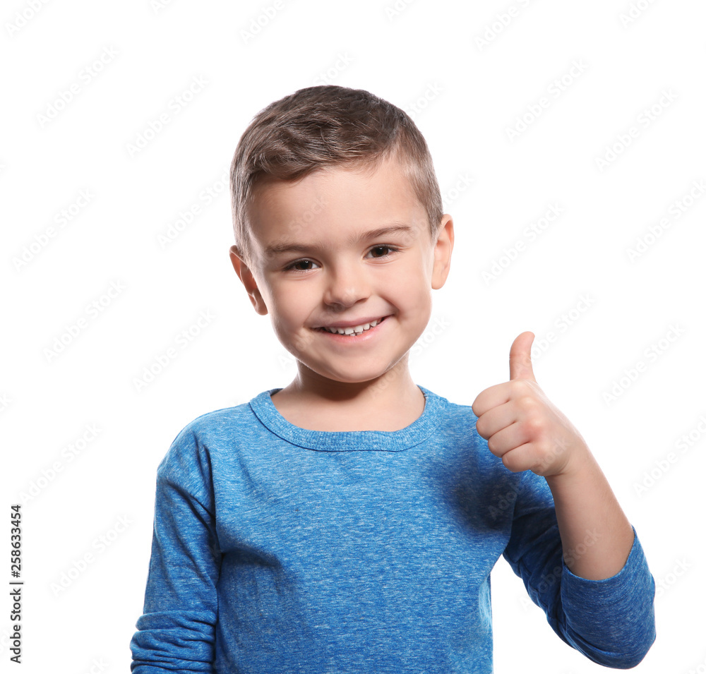 Little boy showing THUMB UP gesture in sign language on white background Little boy showing THUMB UP gesture in sign language on white background