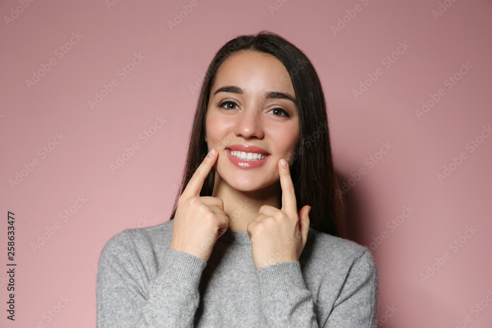 Woman showing LAUGH gesture in sign language on color background Woman showing LAUGH gesture in sign language on color background