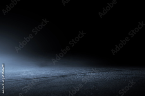 Asphalt surface, racetrack of fog on a black background