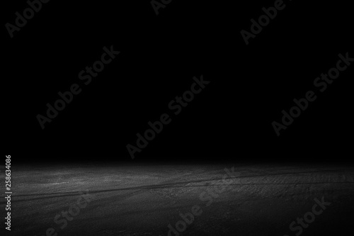Asphalt surface, racetrack on a black background