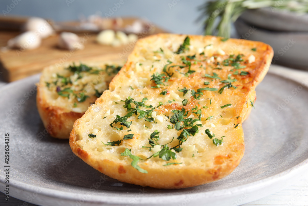 Plate with delicious homemade garlic bread on table Plate with delicious homemade garlic bread on table