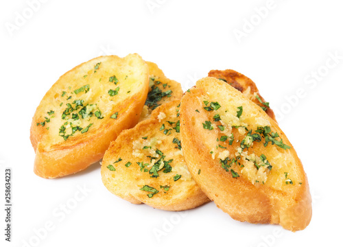Slices of tasty garlic bread with herbs isolated on white