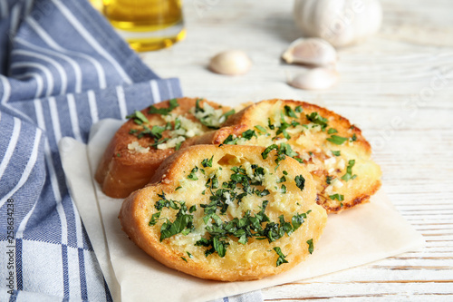 Wallpaper Mural Slices of tasty garlic bread with herbs on table Torontodigital.ca