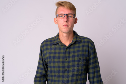 Portrait of young blonde hipster man wearing eyeglasses © Ranta Images