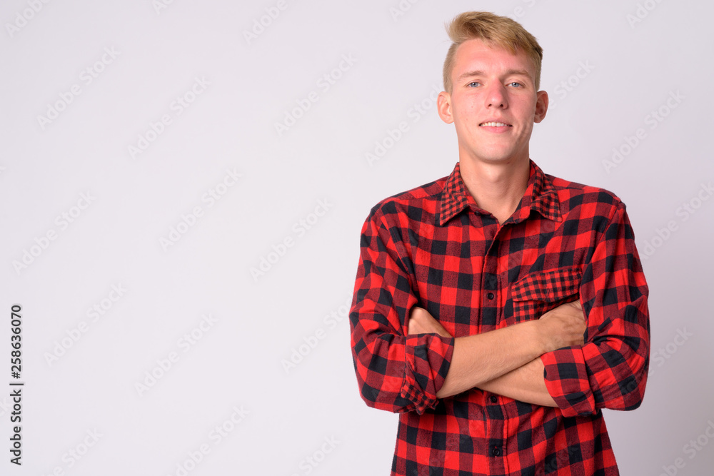Happy young blonde hipster man smiling with arms crossed Happy young blonde hipster man smiling with arms crossed
