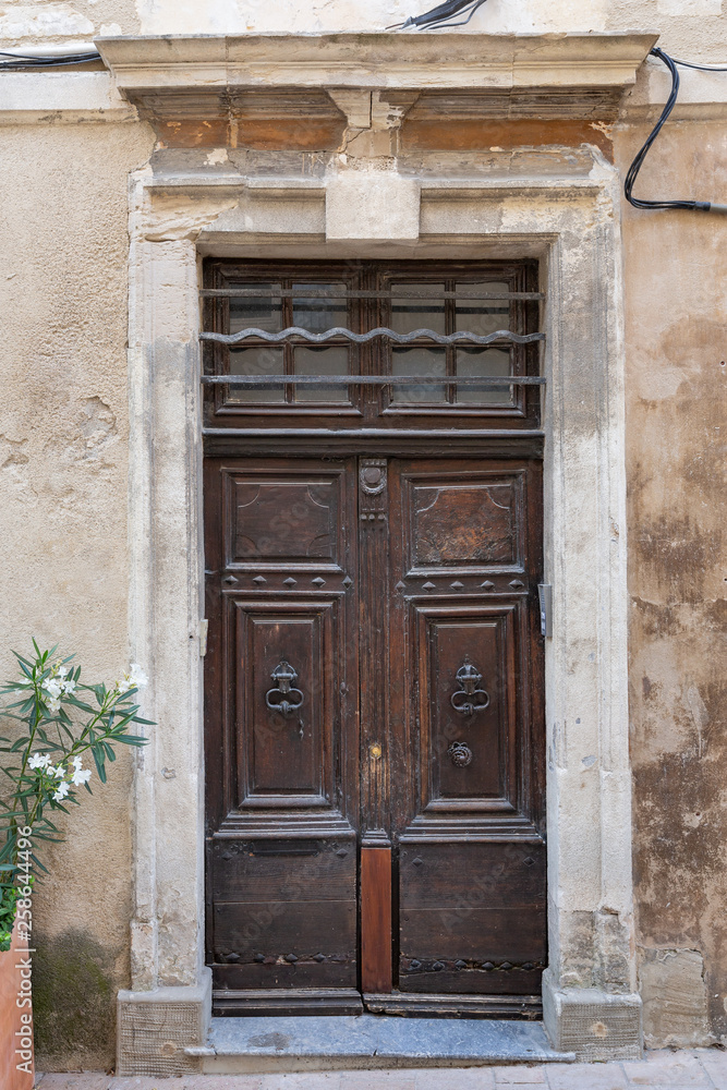 Character filled old wooden door in St Remy de Provence, France Character filled old wooden door in St Remy de Provence, France