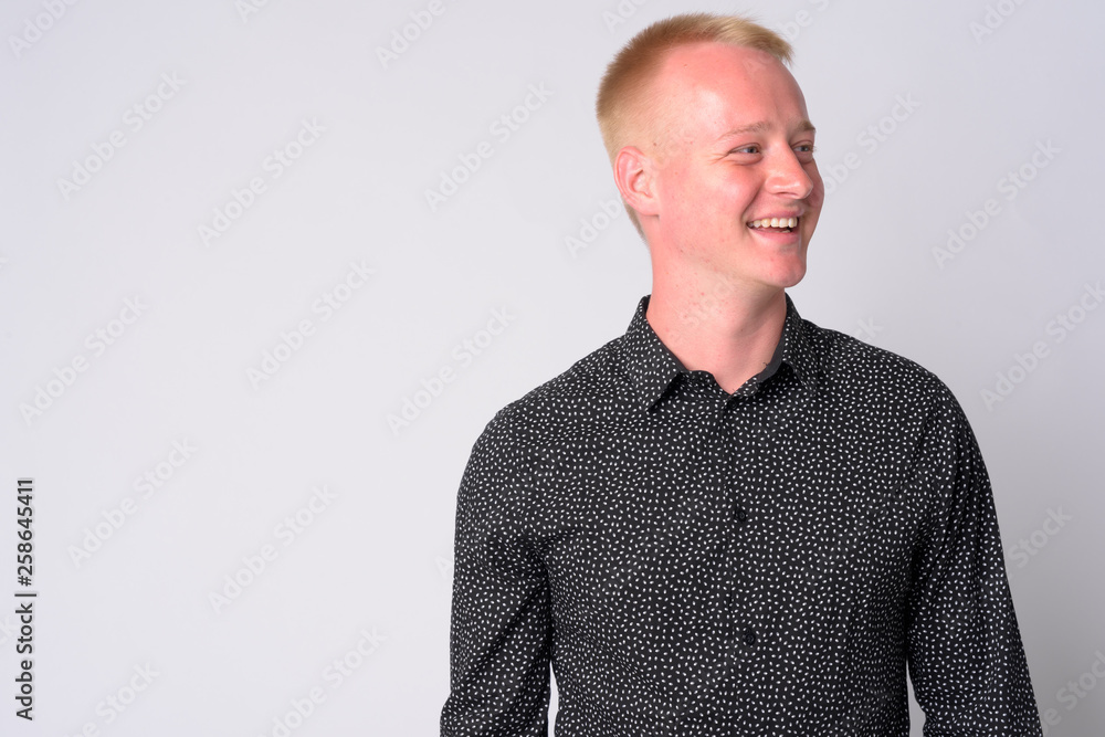 Portrait of happy young businessman with blond hair thinking Portrait of happy young businessman with blond hair thinking