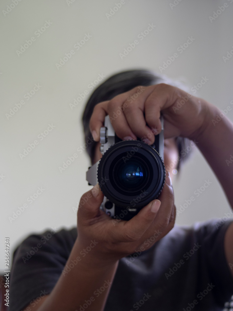 Men Photographer holding vintage lens 