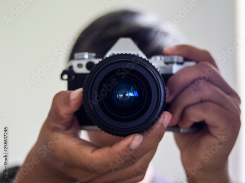 Men Photographer holding vintage lens  © maewshooter